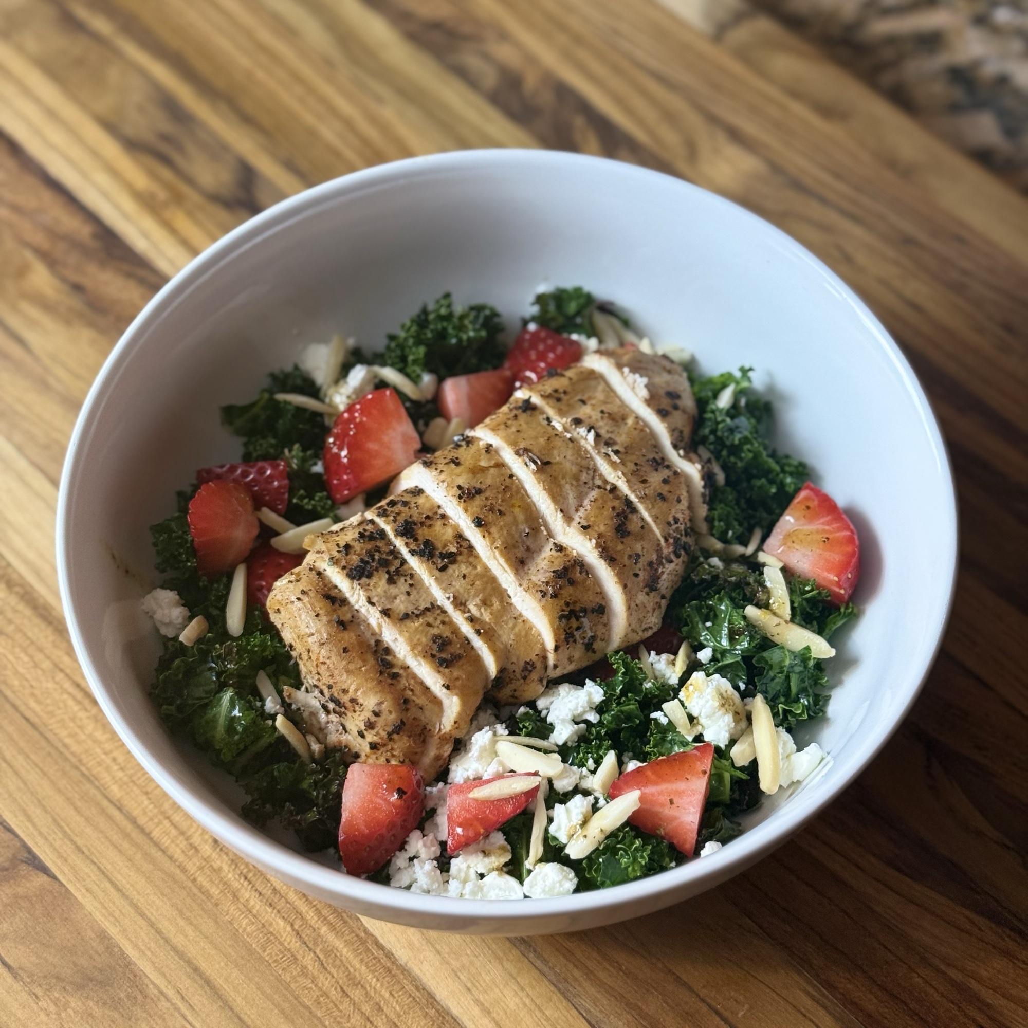 Kale and strawberry salad with chicken, prepared by Doble Culinary