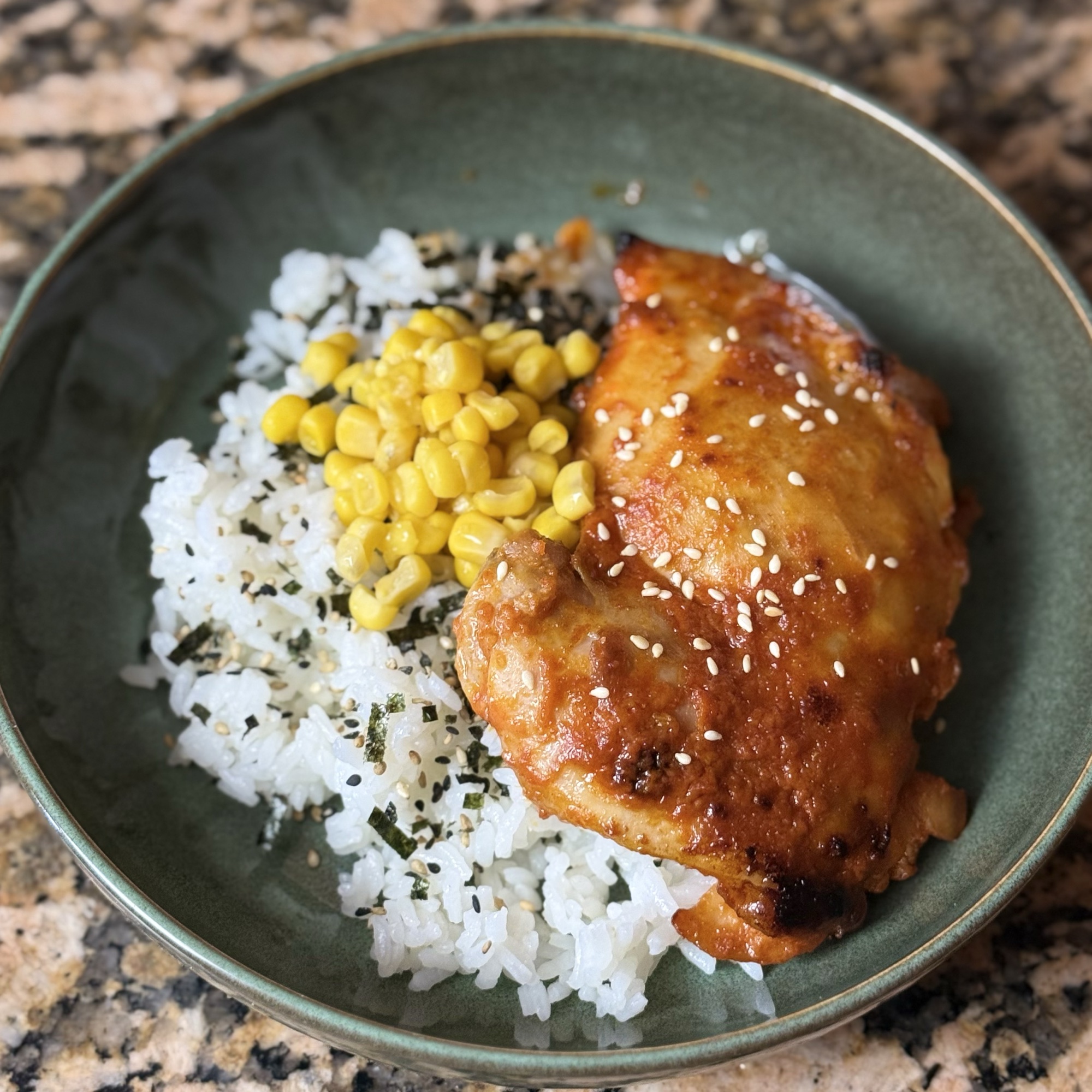 Sesame chicken with rice and corn, prepared by Doble Culinary